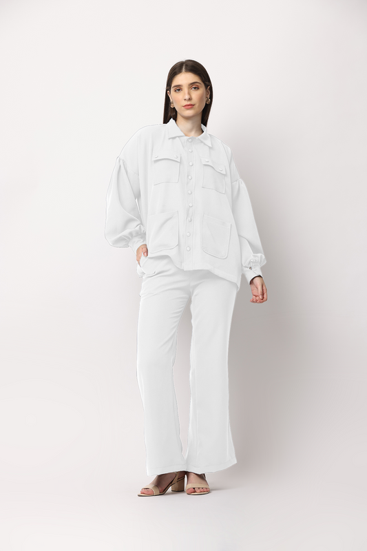 Matching white coloured loose fitted shirt and trouser set for those who want to keep it simple and comfortable. This long shirt features balloon sleeves with multi-front pockets and drop shoulders paired with wide-legged trousers featuring concealed elastication and side pockets.