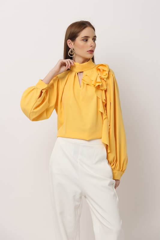 This timeless blouse is defined with full blouson sleeves, a V-neck cut-out and a statement crepe high-low frill. Style it with Ferlyy's signature tailored trousers for an elevated effect or pair it with your favourite denim for a relaxed Friday look