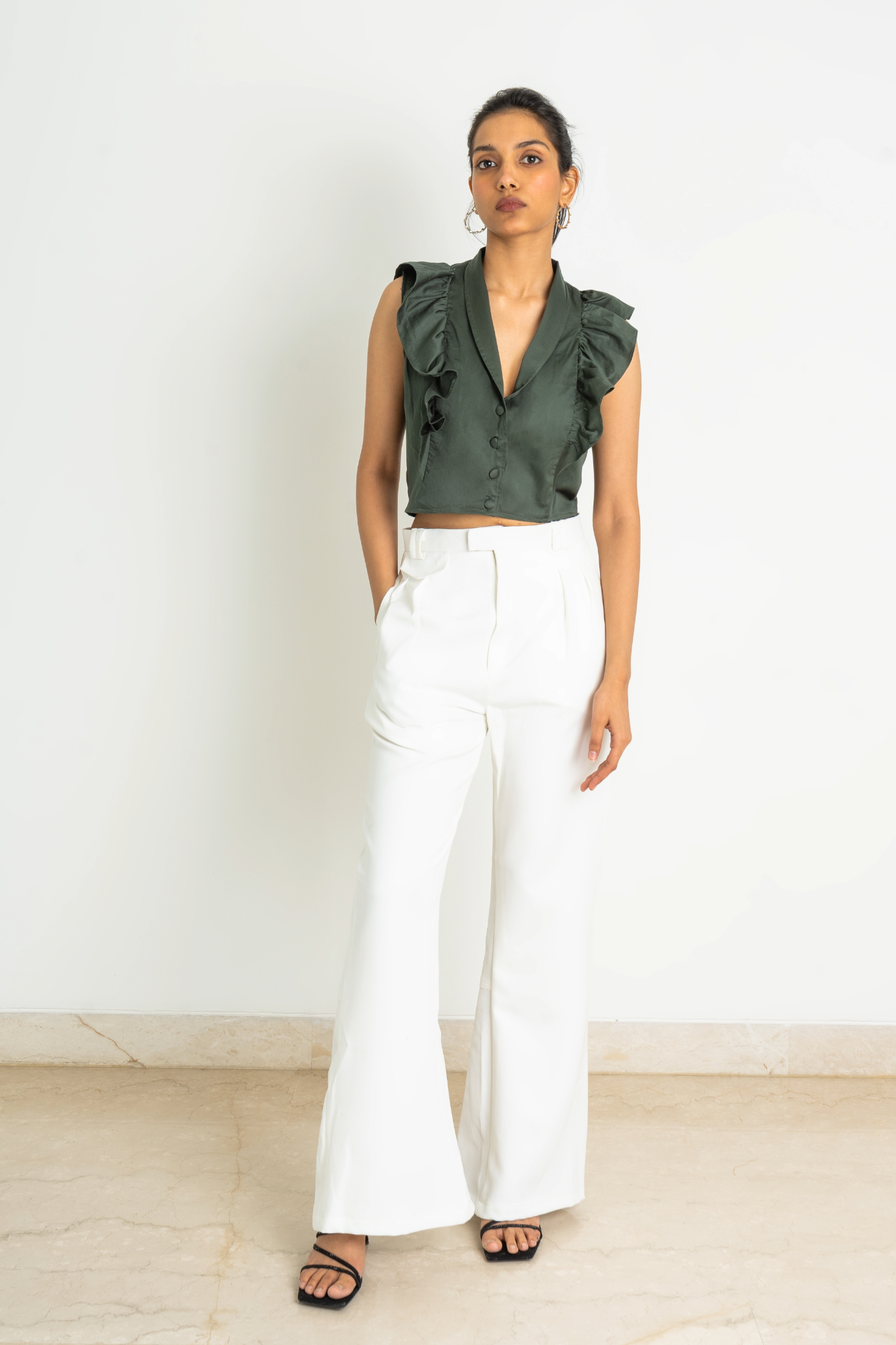 Trousers in woven fabric made from a viscose blend with pinched seams, split hem on reverse and a zip fly and hook eye fastener, detailed belt, diagonal side pockets, small flap on front and legs with gently flared hems.