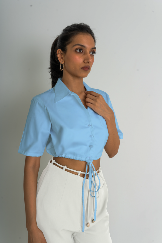 Made from crisp cotton poplin, Ferlyy’s white crop button-down shirt features a front pocket and a drawstring to cinch the cropped hem. 100% Cotton