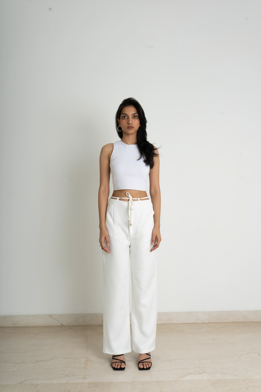 Wide legged trousers in knitted fabric. High waist with a zip fly and a concealed button and hook-and-eye fastener. Diagonal side pockets, and wide, straight legs with drawstrings attached to the belt for added comfort in white colour making it easy to pair with anything.