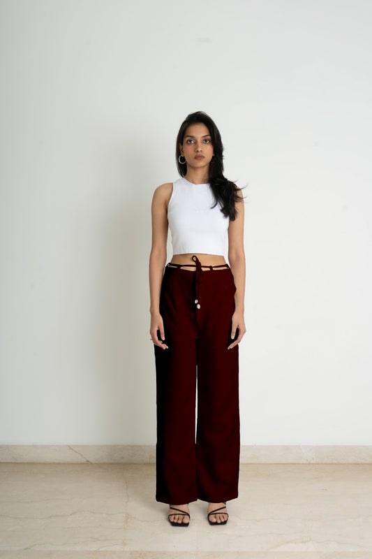 Wide legged trousers in knitted fabric. High waist with a zip fly and a concealed button and hook-and-eye fastener. Diagonal side pockets, and wide, straight legs with drawstrings attached to the belt for added comfort in an amazing deep crimson colour