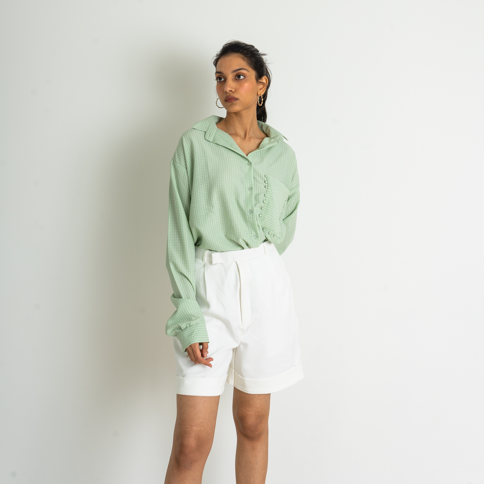 Tailored shorts in a stretchable and breathable fabric. High waist with pleats at the front, and a zip fly with a concealed button and hook-and-eye in the waistband. Diagonal side pockets, and folded legs with creases front and back.